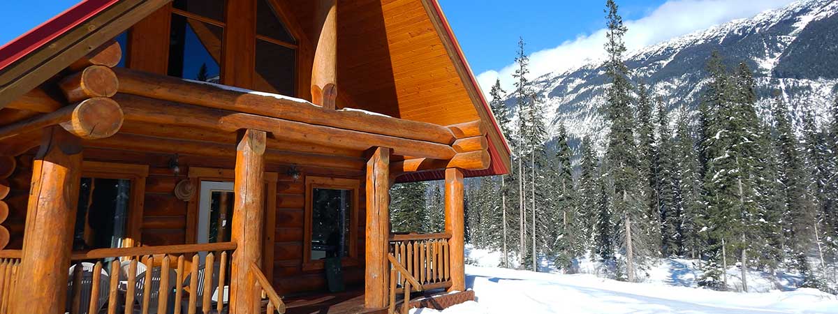 Kicking Horse River Chalets log cabin in winter